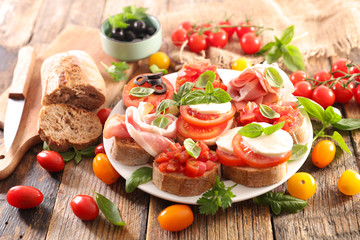 assorted bruschetta with tomato, mozzarella, olive