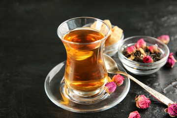 Tasty Turkish tea in traditional glass on table