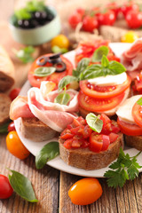 assorted bruschetta with tomato, mozzarella, olive