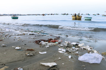 Dirty sand beach with rubbish and garbage in mui ne vietnam