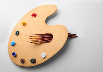 Paint brushes with wooden palette, isolated on white