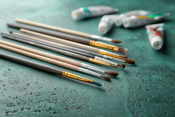 Paint brushes on color background