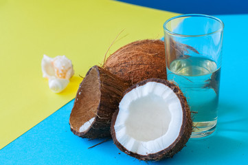 Whole coconuts and coconut water . Doutone background.