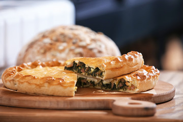 Delicious pie on wooden board in bakery