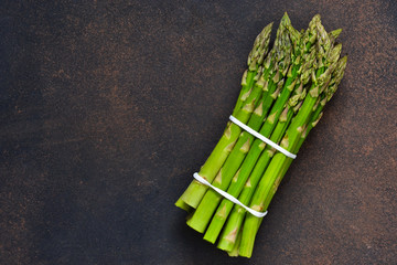 Young, green asparagus on a dark, grunge background. Organic food.