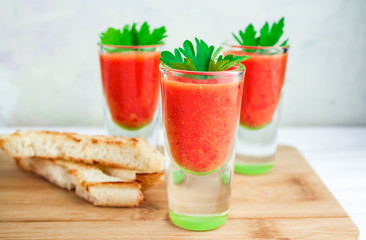 tomato cold gazpacho soup with croutons on the board, close-up