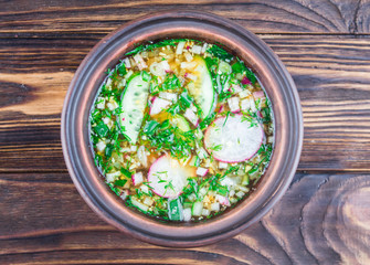 Russian soup - okroshka with kvass, on a wooden background