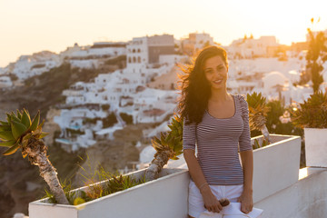 Fototapeta na wymiar Santorini travel tourist brunette woman visiting famous white Oia village.
