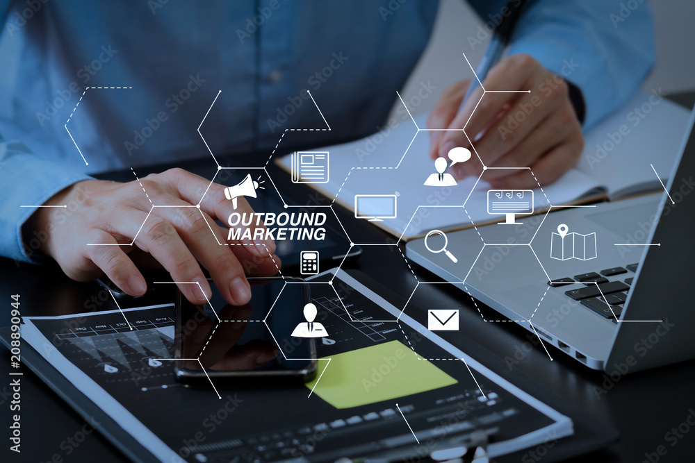 Poster close up of businessman working with smart phone and digital tablet and laptop computer on wooden de
