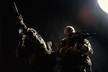 Group of security forces in Combat Uniforms with rifles