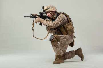 Soldier in camouflage holding rifle