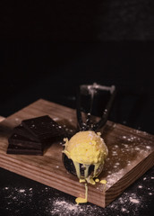 homemade vanilla ice cream with chocolate, on dark background