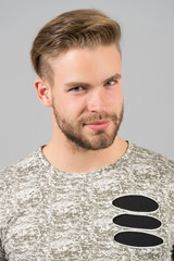 Male beauty concept. Man bearded unshaven guy in stylish shirt with ripped details. Man with...