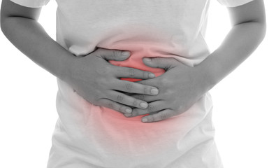 Man suffering from abdominal pain on white background.