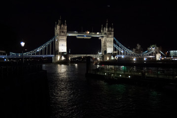 Fototapeta na wymiar Tower bridge with night illumination in London, United Kingdom. Bridge over Thames river with dark water with nice architecture. Structure and design. Wanderlust and vacation concept