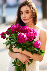 Spring / Summer Style. Beautiful Young Brunette Woman In A Nice Spring Dress With A Bouquet Of Pions. Beautiful Spring Street. Fashion Spring Summer Photo.
