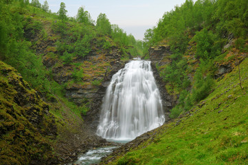 Long exposure image of the Dalfossen Waterfall. Lyngen Alps mountains, Norway. Nature landscape.