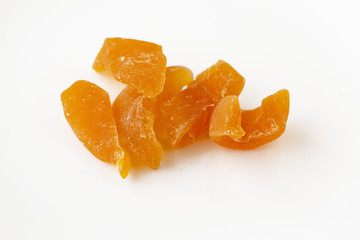 Close-up of pieces of dried melon. Isolated on white