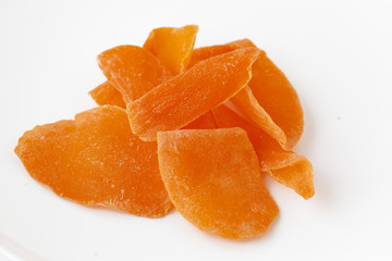 Close-up of dried mango pieces. Isolated on white