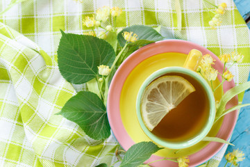 Cup of herbal tea with linden blossoms and lemon