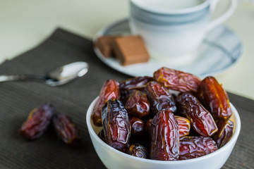 Sweet organic dates fruit in small white bowl