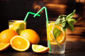 Delicous healthy orangeade on wooden background in studio photo