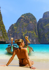 Cute woman relaxing on the summer beach.