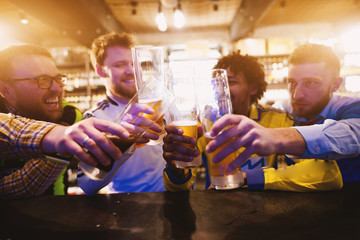 Football fans are saluting with beer pints after the game.