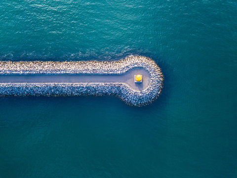 conceptual geometric horizontal line road to the lighthouse in the sea view from above. aerial photo view from the top