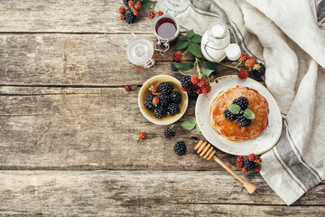 BlackBerry pancakes with fresh berries. Food background with copy space. Top view