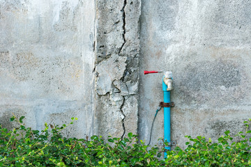 Rusty and old water tap on wall with space for your text.