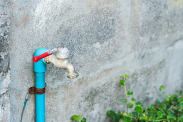 Rusty and old water tap on wall with space for your text.