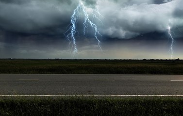 Front view while driving on the highway. Under heavy rain and lightning storms.