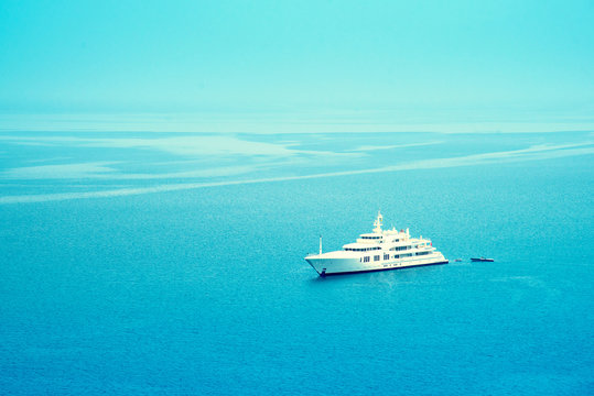 The beautiful landscape with a white liner in the middle of a blue sea