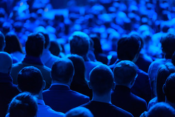 Audience listens to the lecturer at the conference hall