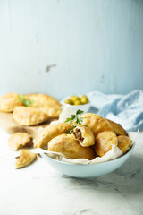 Homemade hand pies with minced meat and olives