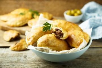Homemade hand pies with minced meat and olives