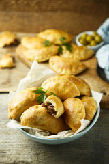 Homemade hand pies with minced meat and olives