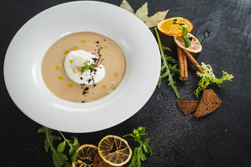 Mushroom cream soup on black background