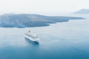 Cruise ship near the sea coast of Santorini island, Greece.