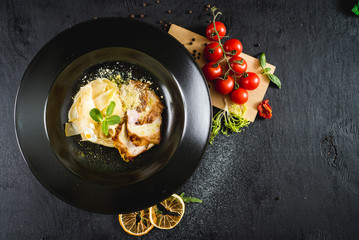 Tasty italian pasta on black background