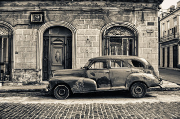 black and white tone of old chevrolet parked in the street of havana