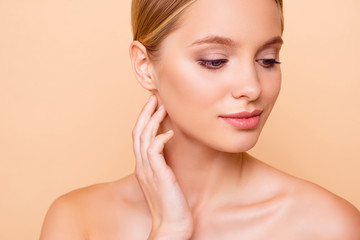 Close up cropped portrait of pretty charming girl with perfect ideal face skin after tightening lifting botox injection isolated on beige background. Wellness wellbeing concept