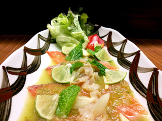 Salmon salad on a plate with fresh vegetables.