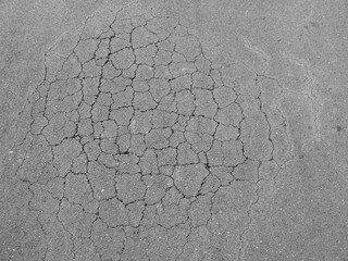 Old worn and cracked asphalt with cracks