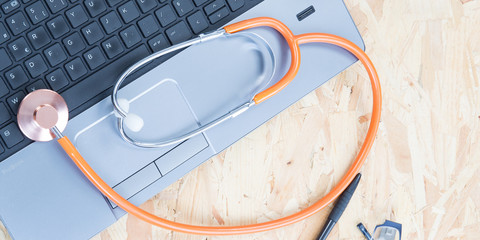 Medical stethoscope on a laptop computer in closeup
