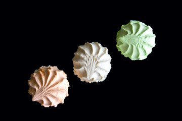 delicious colorful merengues on  black background