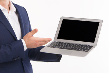 Male hand points to a laptop screen with copy space on white background