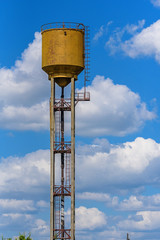 a water tower on a background of clouds