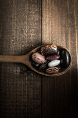 Pile of Colorful Beans on Dark Wooden Background